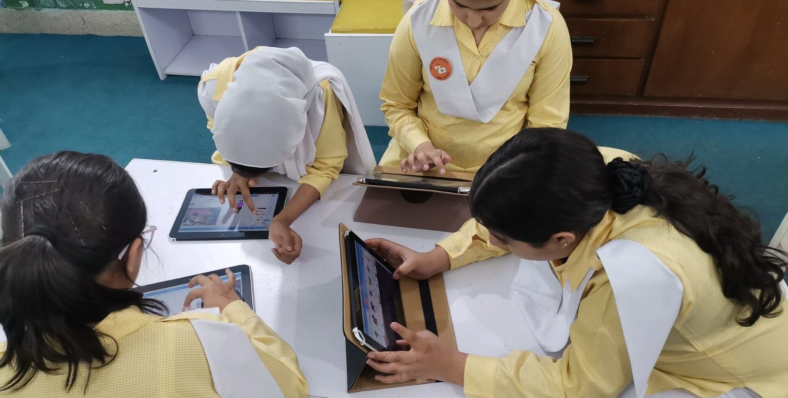 Children in a classroom learning with laptops