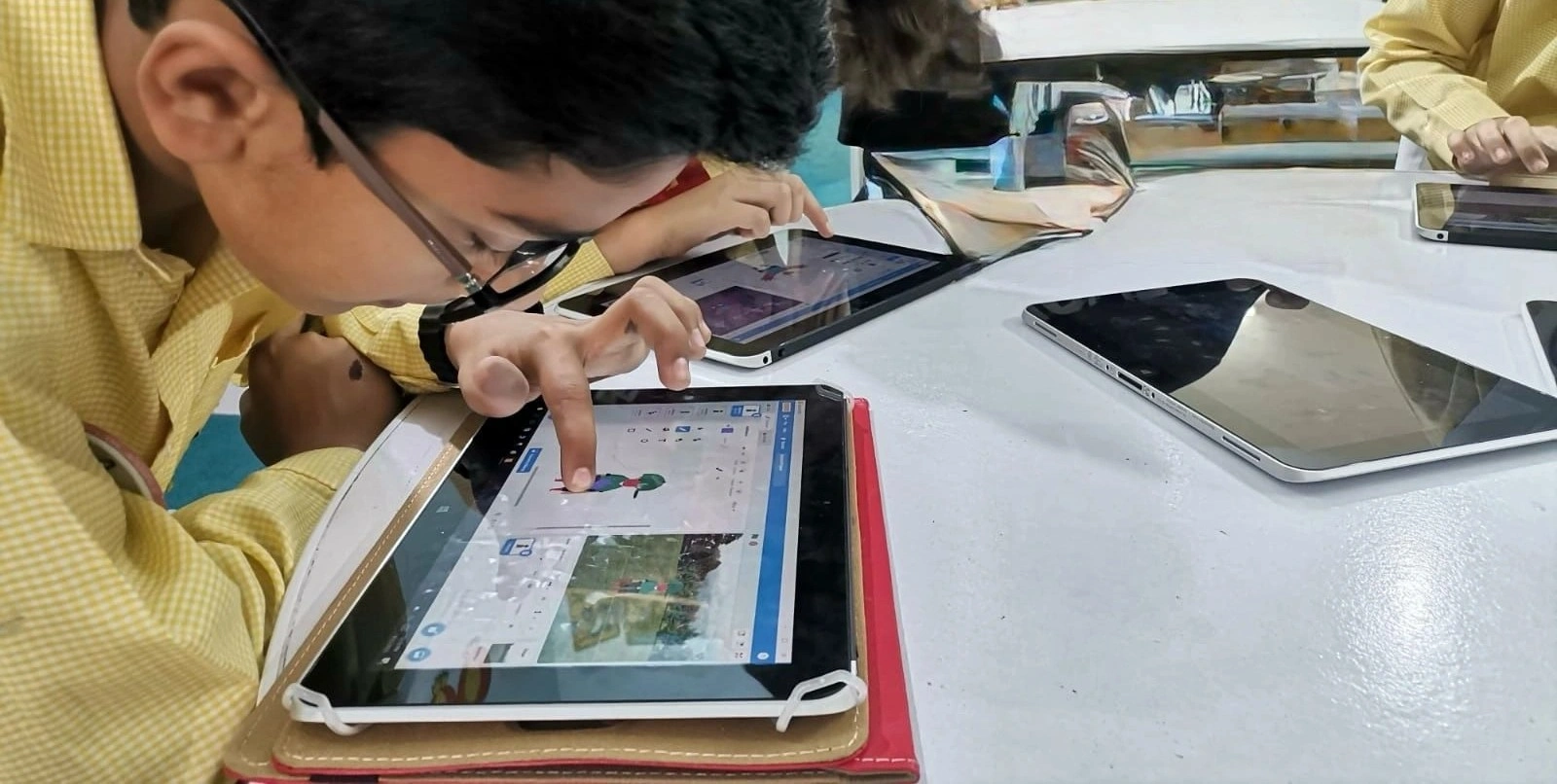 A teacher helping a student with a robotics project